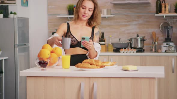 Sexy Housewife Using Smartphone alt