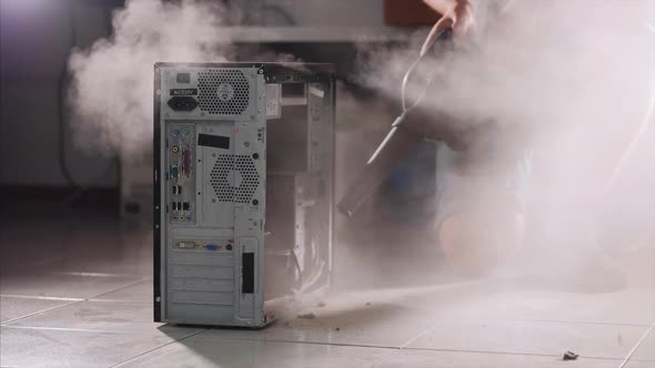 A Man with a Vacuum Cleaner is Cleaning the Computer alt