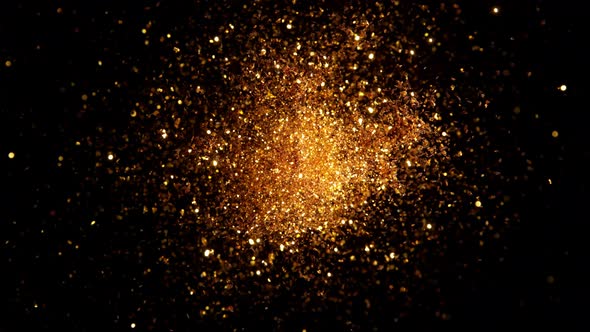 Super Slow Motion Shot of Round Golden Glittering Explosion Isolated on Black at 1000Fps alt