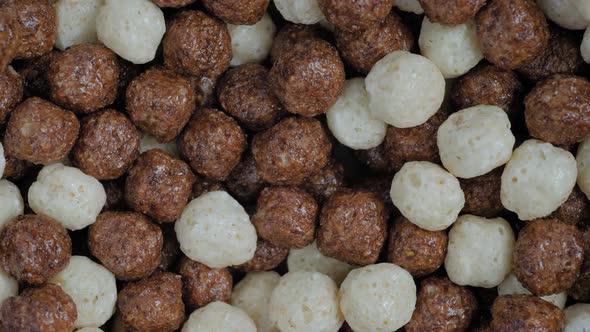 Heap of Brown and White Chocolate Cereal Balls on Rotating Surface  Close Up