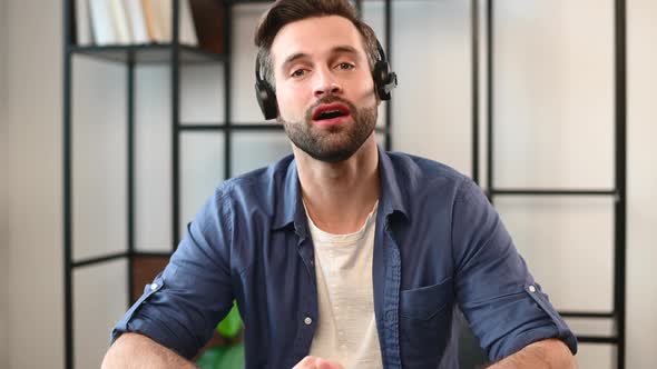 Smiling Young Bearded Guy Wearing Headset alt
