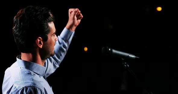 Male business executive giving a speech alt