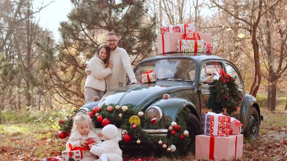 Family at the Car in Christmas Decorations
