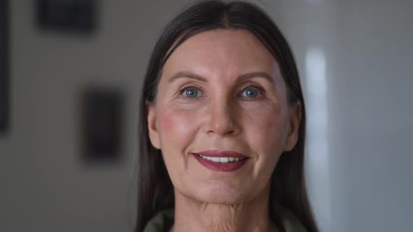 Portrait Happy 50s Mature Elderly Woman Standing Inside Living Room Spbi alt