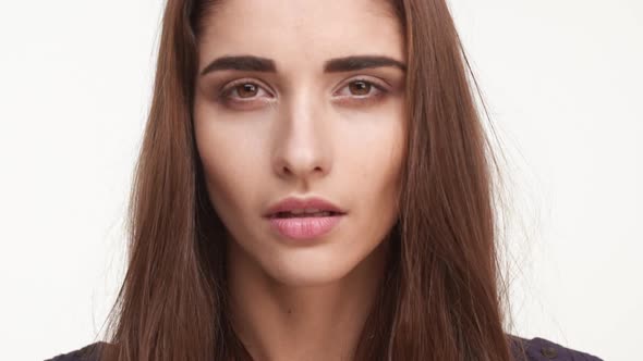 Close Up Footage of Beautiful Caucasian Female with Long Brown Hair in Looking at Camera in alt