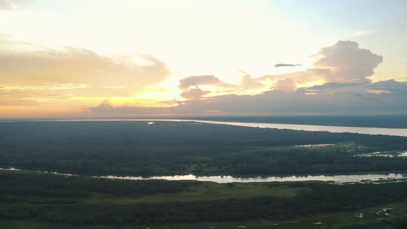 Aerial view during sunset in Amazonia, amazon river, jungle in Peru 4K