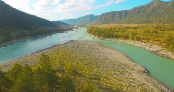 Low Altitude Flight Over Fresh Fast Mountain River with Rocks at Sunny Summer Morning. alt