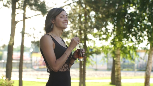 Girl Drinking Cola In Park alt