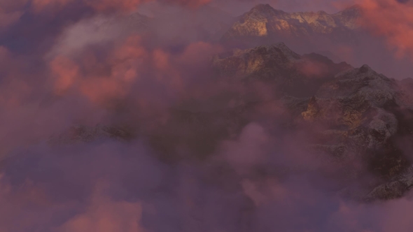 Flying Over The Mountains In Mist At Sunset