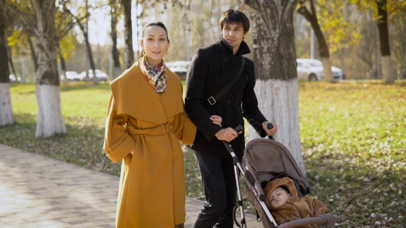 Young Girl And a Man Walks Along The Avenue Of The City