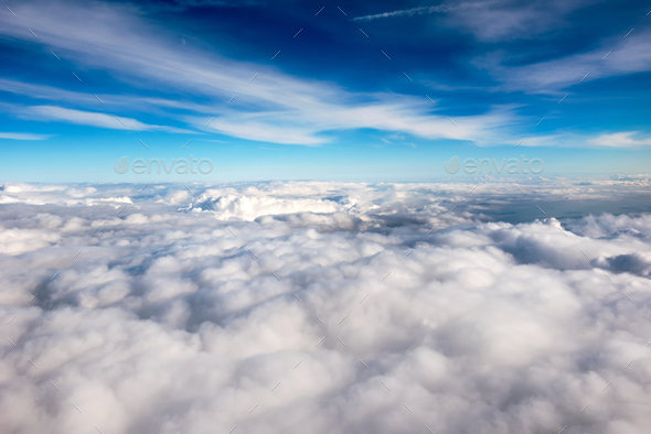 Blue sky above a layer of white clouds - Stock Photo - Images