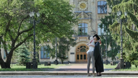 Graduand is Meeting the Friend and Hugging alt