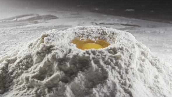 Egg Dropping Into Flour