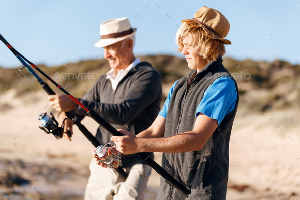 Senior man fishing with his grandson - Stock Photo - Images