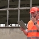 Worker With a Walkie-talkie at a Construction Site - VideoHive Item for Sale