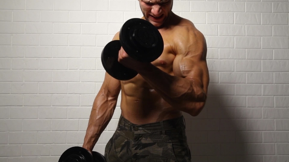 Strong Man Doing Exercise With Dumbbells