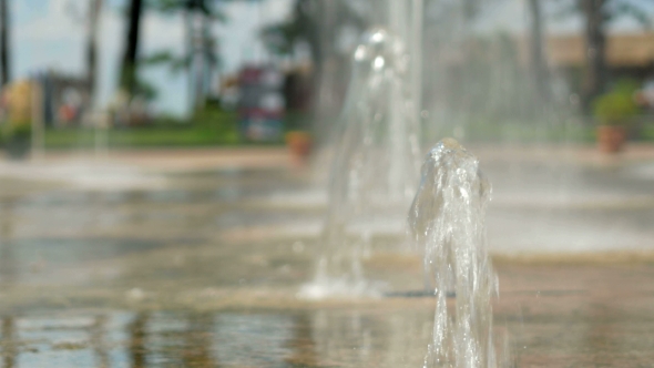 Water Pouring Out Of The Ground. The Flow Of Water Falls To The Ground
