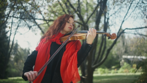 Beautiful Girl With Red Hair, With Bright Lipstick Plays On Violin