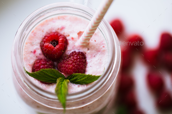 Pink raspberry smoothie in a mason jar with straws - Stock Photo - Images