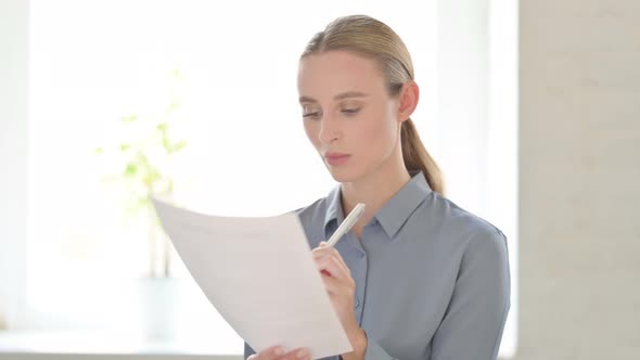 Portrait of Woman Reading Documents alt