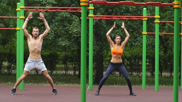 Workout - Young Couple Jumping Together