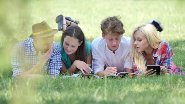Happy Students Are Reading Lying on a Grass alt