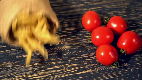 Tomato and Pasta on Wooden Background