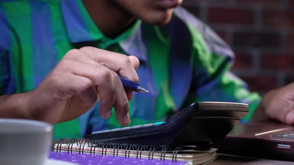 Close Up Man Hand Using Calculator alt