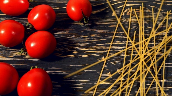 Tomato and Pasta on Wooden Background