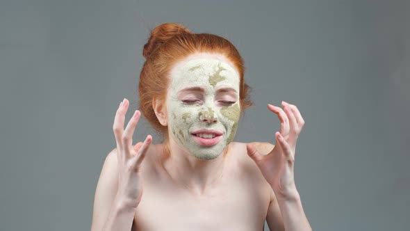 Beauty Portrait Face Mask. Anti-aging Facials. Young Woman Applies a Mask To the Face