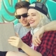 Laughing Young Hipster Couple Checking a Tablet
