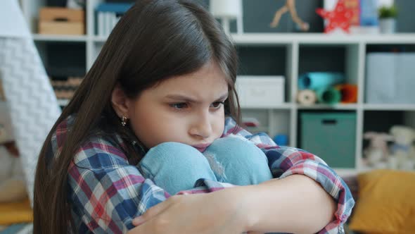 Sad Lonely Girl Sitting Alone Sighing Feeling Unhappy and Adandoned Indoors at Home alt