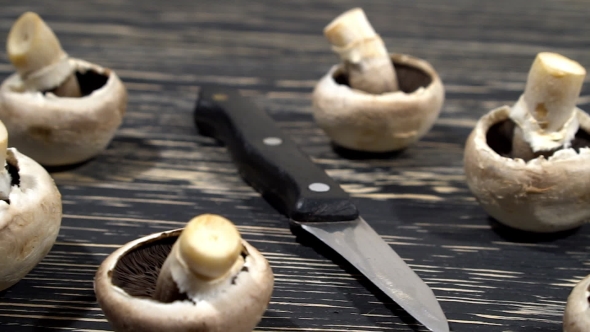 Mushrooms On a Wooden Board With a Knife.