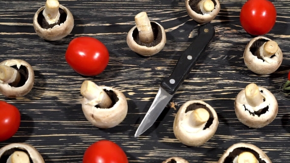 Mushrooms And Tomatoes On a Kitchen Board