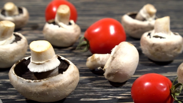 Mushrooms, Oil And Tomatoes On a Kitchen Board