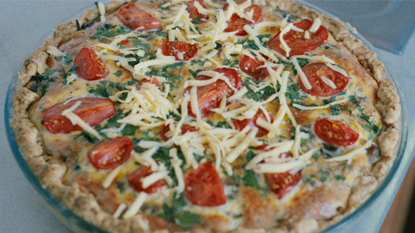 Putting Cheese Topping on Freshly Baked French Quiche.
