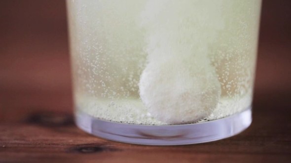 Effervescent Pill Dissolving In Glass Of Water alt