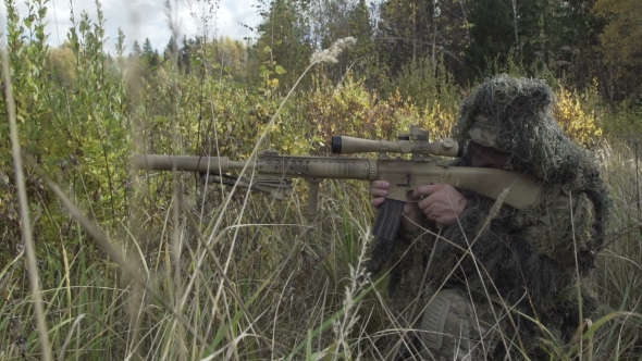 Sniper Rifle In Protective Suit Sitting In a Field, Stock Footage ...