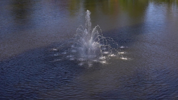 Park Fountain. Fountain Water Splashing On Lake Surface.