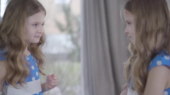 Close-up of Two Identical Twins Quarreling at Home. Charming Brunette Twin Sisters Arguing Indoors alt