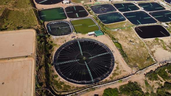 Massive pond shrimp farms on Vietnam coastline, aerial orbit shot alt