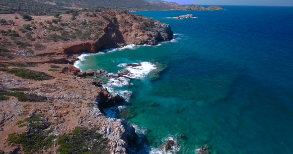 Blue Sea, Waves Breaking In Cliffs At Shore