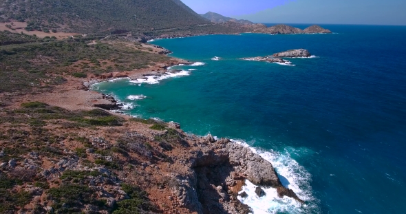 Blue Sea, Waves Breaking In Cliffs At Shore