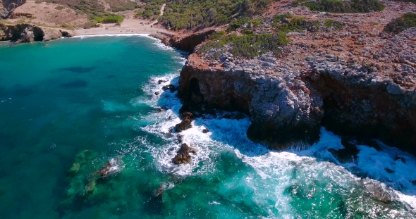 Blue Sea, Waves Breaking In Cliffs At Shore