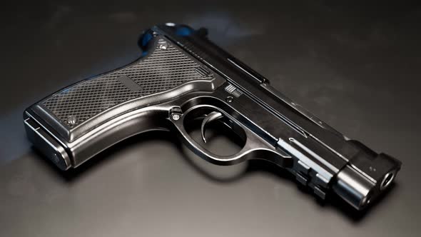 Gun with fingerprints in UV light. Biometric identification in ultraviolet rays alt