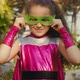 Beautiful Baby Girl in the Superhero Costume Kid Plays Superhero Child Dressed in a Pink Cloak