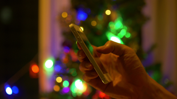 Using Smartphone At Christmas Tree
