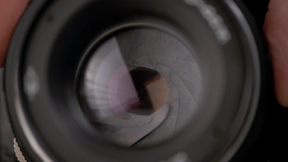 The Diaphragm Of Old Camera Lens Aperture With Warm Light Bokeh alt