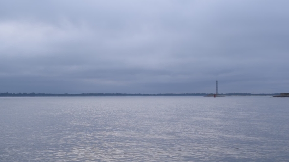 Bird Flies Above Calm Light Blue Water Surface