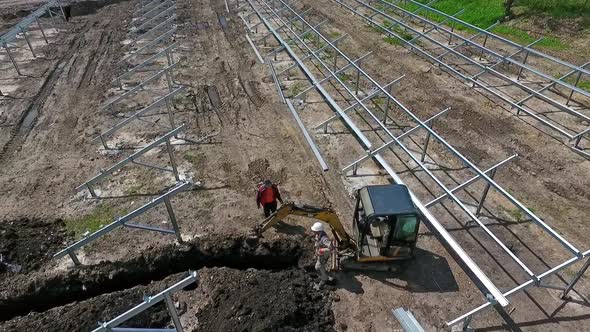 Aerial view of excavator. Tracked excavator at work on construction site alt